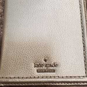 Card holder by Kate Spade. Can hold up to 7 cards. 

Hardly used.